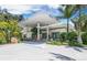 Unique restaurant and bar with a retro gas station design, featuring an overhanging canopy and palm trees at 580 Russell St, Longboat Key, FL 34228