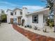 Inviting entrance to this home with a charming brick walkway and well-maintained landscaping at 580 Russell St, Longboat Key, FL 34228