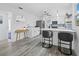 A modern kitchen with white cabinets, an island with seating, and stainless steel appliances at 580 Russell St, Longboat Key, FL 34228