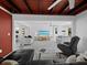 Open-concept living room with a red accent wall, contemporary decor, and abundant natural light at 580 Russell St, Longboat Key, FL 34228