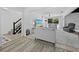 Bright living room with hardwood floors, neutral decor, and views of the outdoor pool at 580 Russell St, Longboat Key, FL 34228