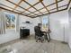 Bright home office featuring a coffered ceiling, tile flooring, and a desk with a comfortable office chair at 580 Russell St, Longboat Key, FL 34228