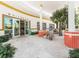 Outdoor dining area with views through open doors, and retro architectural design details like colorful tile and globes at 580 Russell St, Longboat Key, FL 34228