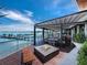 Beautiful outdoor seating area with a fire pit, tables, and panoramic water views of boats and a pier at 580 Russell St, Longboat Key, FL 34228