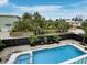Backyard pool and landscaped yard featuring a modern fence and privacy at 580 Russell St, Longboat Key, FL 34228