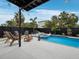 Relaxing pool area with lounge chairs, landscaping, and a covered patio for outdoor entertaining at 580 Russell St, Longboat Key, FL 34228