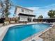 Beautiful backyard pool with ample seating, a covered patio, and lush tropical landscaping at 580 Russell St, Longboat Key, FL 34228