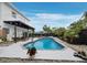 Stunning pool area with a spacious deck, comfortable seating, and privacy fencing at 580 Russell St, Longboat Key, FL 34228