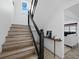 Modern staircase with wood steps, glass railings, and a decorative table with artwork at 580 Russell St, Longboat Key, FL 34228