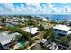Aerial view of waterfront property, highlighting the pool, boat dock and access to the beautiful bay at 602 Baronet Ln, Holmes Beach, FL 34217