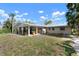 Charming home with large covered patio and well-maintained lawn at 602 Baronet Ln, Holmes Beach, FL 34217