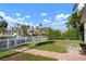 Canal-front backyard with grassy area and boat dock, perfect for waterfront living and enjoying the Florida lifestyle at 602 Baronet Ln, Holmes Beach, FL 34217