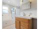Bright bathroom features a shower with glass door, separate soaking tub and white countertops at 602 Baronet Ln, Holmes Beach, FL 34217