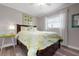 Cozy bedroom with queen bed, wood floors, and window providing natural light at 602 Baronet Ln, Holmes Beach, FL 34217