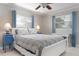 Bright bedroom features a ceiling fan, tile flooring, and ample natural light from the window at 602 Baronet Ln, Holmes Beach, FL 34217