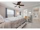 Comfortable bedroom boasts tile flooring, neutral paint, and updated furnishings at 602 Baronet Ln, Holmes Beach, FL 34217