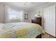 Bright bedroom with wood floors, window views, and classic dresser at 602 Baronet Ln, Holmes Beach, FL 34217