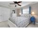 Bedroom boasts tile flooring, neutral paint, and a ceiling fan at 602 Baronet Ln, Holmes Beach, FL 34217