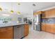 Open concept kitchen features stainless steel appliances, updated countertops and stylish pendant lighting at 602 Baronet Ln, Holmes Beach, FL 34217