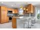 Well-equipped kitchen featuring a breakfast bar, modern appliances, and generous cabinet space at 602 Baronet Ln, Holmes Beach, FL 34217