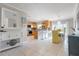 Open kitchen featuring a breakfast bar, stainless steel appliances, and a charming dining area at 602 Baronet Ln, Holmes Beach, FL 34217