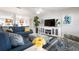 Bright living area with a large sectional, contemporary media cabinet, and coastal decor at 602 Baronet Ln, Holmes Beach, FL 34217