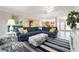 Bright and airy living room featuring a comfortable blue sectional and stylish coastal decor at 602 Baronet Ln, Holmes Beach, FL 34217