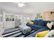Comfortable living room features tile floors, a blue sectional, and an open floor plan at 602 Baronet Ln, Holmes Beach, FL 34217