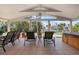 Relaxing outdoor patio with comfortable seating and beautiful views of the lush backyard and canal at 602 Baronet Ln, Holmes Beach, FL 34217