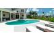 Spacious backyard with pool, spa, and covered patio ideal for entertaining and outdoor living at 603 Emerald Ln, Holmes Beach, FL 34217
