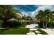 Lush backyard with synthetic grass and access to the canal and boat dock at 603 Emerald Ln, Holmes Beach, FL 34217