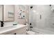 Bright bathroom featuring a white vanity with black hardware, shower/tub combo and painted beach themed decor at 603 Emerald Ln, Holmes Beach, FL 34217