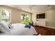 Cozy bedroom features a plush bed, modern furniture, and a sliding door that overlooks the outdoors at 603 Emerald Ln, Holmes Beach, FL 34217
