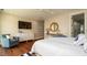 Comfortable bedroom with a dresser, a round accent mirror, and a chair for relaxing in a quiet setting at 603 Emerald Ln, Holmes Beach, FL 34217