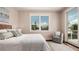 Relaxing bedroom with wood floors, a decorative chair, and views of the water at 603 Emerald Ln, Holmes Beach, FL 34217