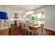 Bright dining area with wood floors, modern chandelier, and seamless access to the outdoor pool area at 603 Emerald Ln, Holmes Beach, FL 34217