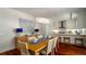 Chic dining area with a chandelier, stylish table setting, and open access to the kitchen at 603 Emerald Ln, Holmes Beach, FL 34217
