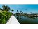 Private dock and waterway access, enhanced by verdant foliage and tropical landscaping at 603 Emerald Ln, Holmes Beach, FL 34217