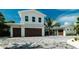 Charming home featuring a three-car garage and well-maintained landscaping for a welcoming entrance at 603 Emerald Ln, Holmes Beach, FL 34217