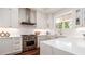 Modern kitchen with stainless steel appliances, white cabinetry, and ample counter space at 603 Emerald Ln, Holmes Beach, FL 34217