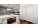 Elegant kitchen featuring an island with a built-in microwave and abundant storage at 603 Emerald Ln, Holmes Beach, FL 34217