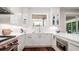 Contemporary kitchen with white cabinets, stainless steel appliances, and sleek countertops at 603 Emerald Ln, Holmes Beach, FL 34217