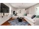 Bright living room with a sectional sofa, hardwood floors, and stylish decor at 603 Emerald Ln, Holmes Beach, FL 34217
