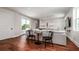 Spacious living room with hardwood floors, balcony access, and cozy seating arrangement at 603 Emerald Ln, Holmes Beach, FL 34217