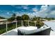 Waterfront home roof deck with daybed and views of the canal and tropical foliage at 603 Emerald Ln, Holmes Beach, FL 34217
