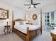 Bedroom with dark wooden poster bed and outdoor views at 6512 Midnight Pass Rd # 303, Sarasota, FL 34242