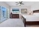 Relaxing bedroom with ceiling fan, dresser with TV, and outdoor views at 6512 Midnight Pass Rd # 303, Sarasota, FL 34242