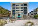 Beachfront building with balconies and a community pool, offering luxury coastal living at 6512 Midnight Pass Rd # 303, Sarasota, FL 34242