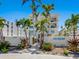 Beautiful condo building entrance with lush landscaping and striking architectural details at 6512 Midnight Pass Rd # 303, Sarasota, FL 34242