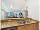 Granite countertops highlight this open kitchen's stainless steel sink and modern design at 6512 Midnight Pass Rd # 303, Sarasota, FL 34242